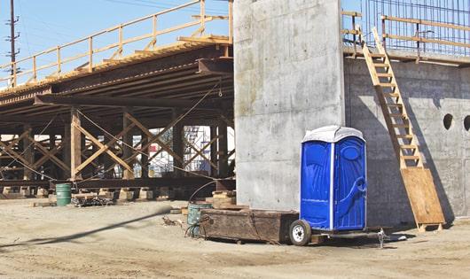 rows of porta potties at a job site, providing essential amenities for workers